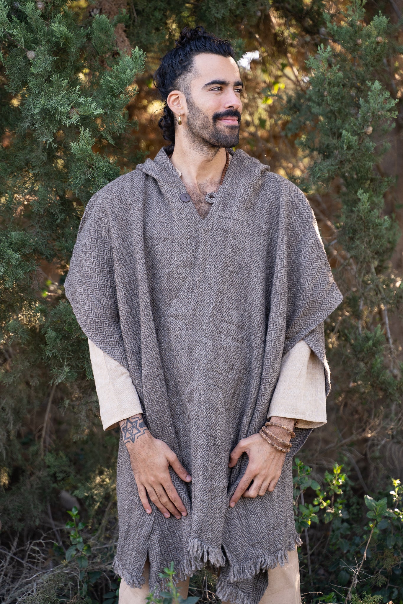 Man wearing grey wool hooded poncho for men