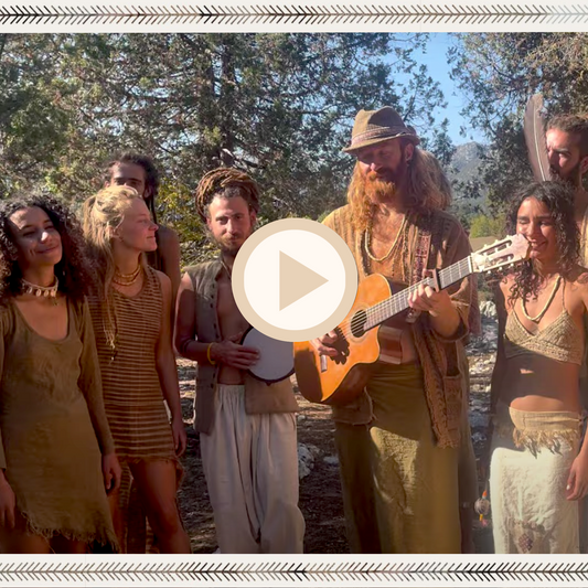 Community music gathering in the woods with guitar and hand drum, people dressed in organic cotton, khadi cotton, and hemp garments