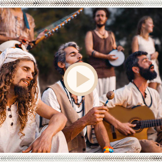 Close view of musicians singing and playing guitar outdoors, dressed in natural boho outfits with raw silk textures.