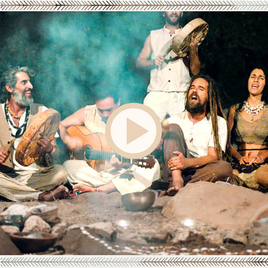 Night song circle with guitar and frame drum, singers wearing hippie tribal clothing in natural earth tones.
