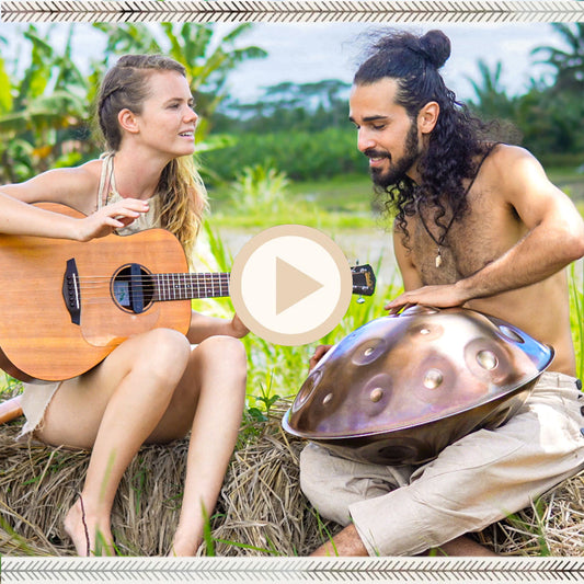 Two musicians sitting in nature with guitar and handpan, dressed in earthy boho outfits, including raw silk and natural cotton.