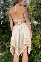 Woman wearing natural fabric skirt and top with tribal blockprint designs in a garden setting, showcasing the Ancient Butterfly Outfit Skirt Top Camel Blockprint.