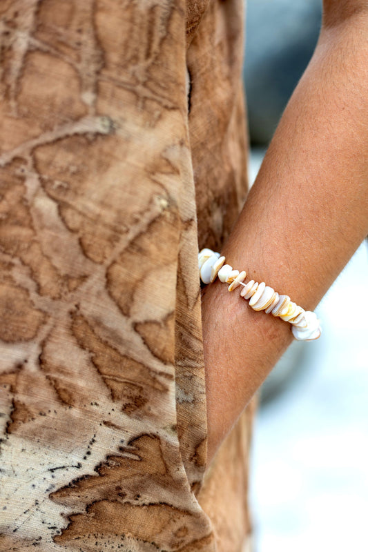 Close up of pockets on natural leaf eco print dress. Botanical dye earthy clothing.
