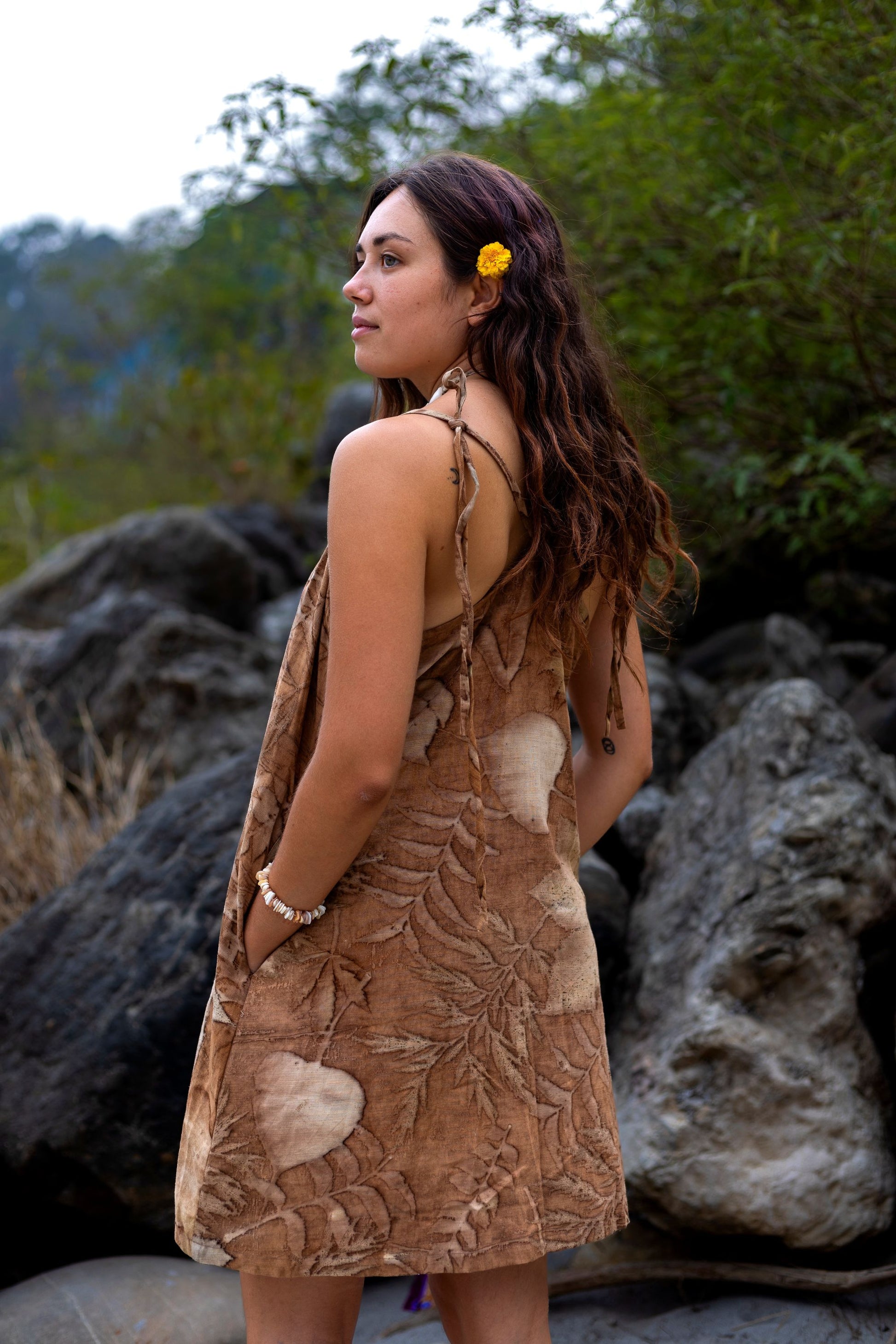 Back view of loose earthy short dress with pockets. Eco printed leaf pattern apparel.