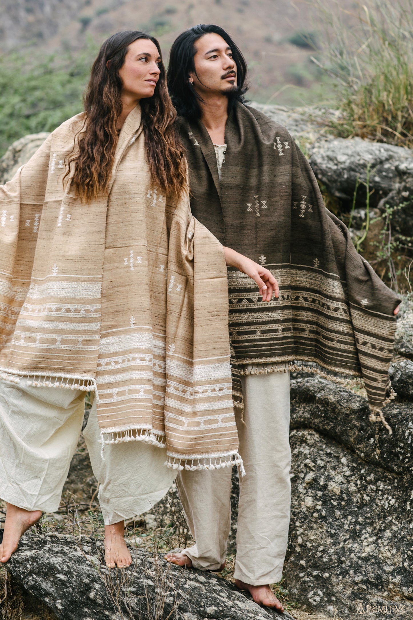 Man and woman modeling large Gujarati tribal shawls in nature. Woman wears the light brown wool silk wrap, showcasing the oversized unisex fit and bohemian drape.