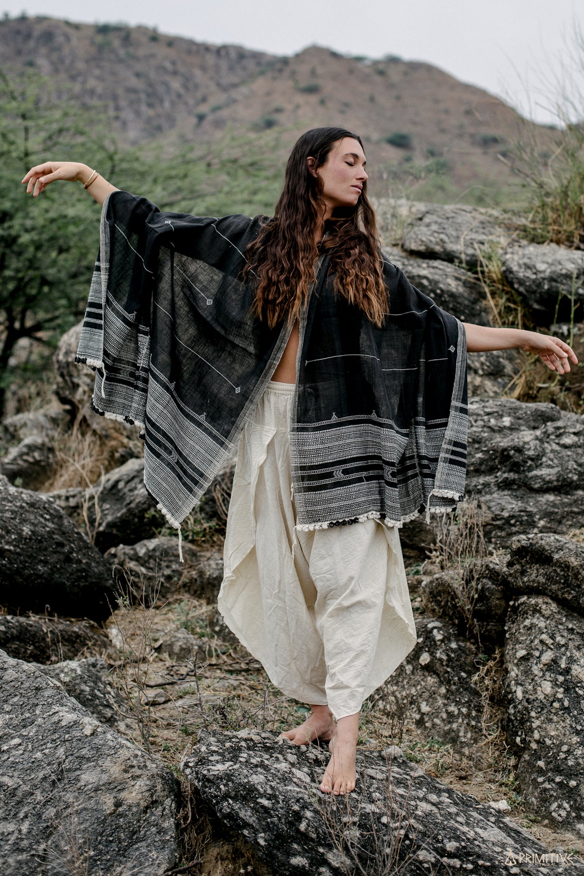  with geometric pattern worn open as a boho wrap outdoors