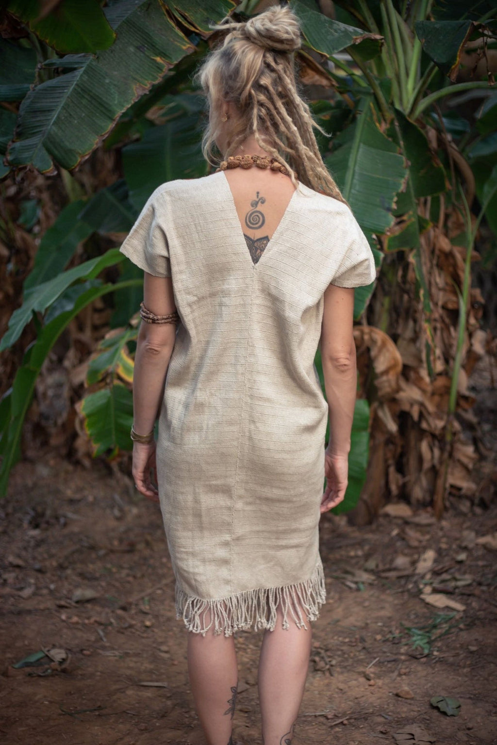 Back view of a woman wearing the Karen Hill Tribe hemp kaftan, showing the V-back design and loose relaxed fit. 