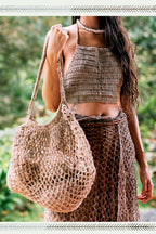 
Large open-weave wild hemp net tote bag in a natural tone, carried on the shoulder in a nature setting
