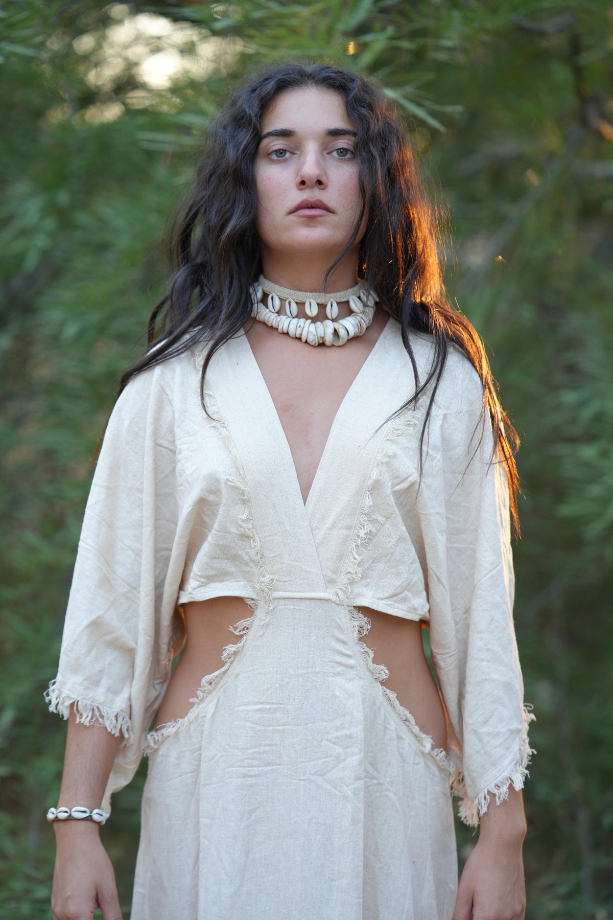 Close-up of the V-neck on a boho raw silk dress in natural white