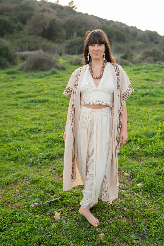 Full-length view of a natural cotton kimono with hand block print borders, worn open over a cream outfit for a flowing boho look.