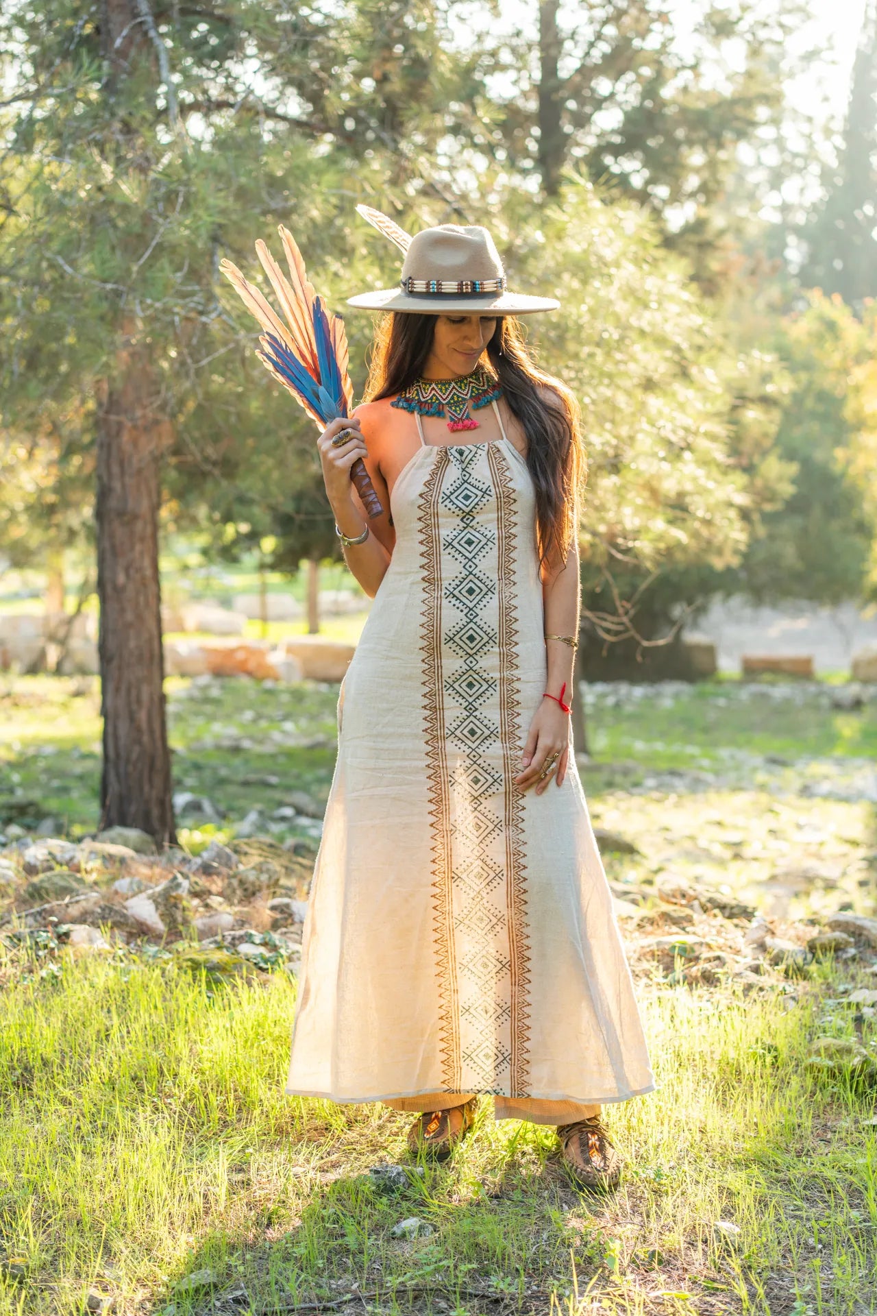 handcrafted cotton dress with ethnic block prints, highlighting the natural fabric and detailed tribal patterns under soft golden sunlight