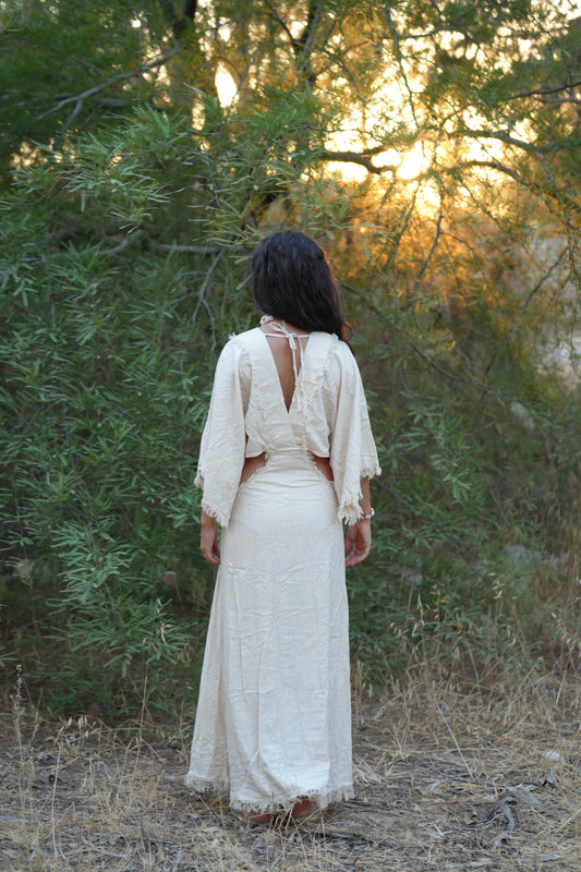 Back view of a flowy raw silk dress in off-white, maxi length