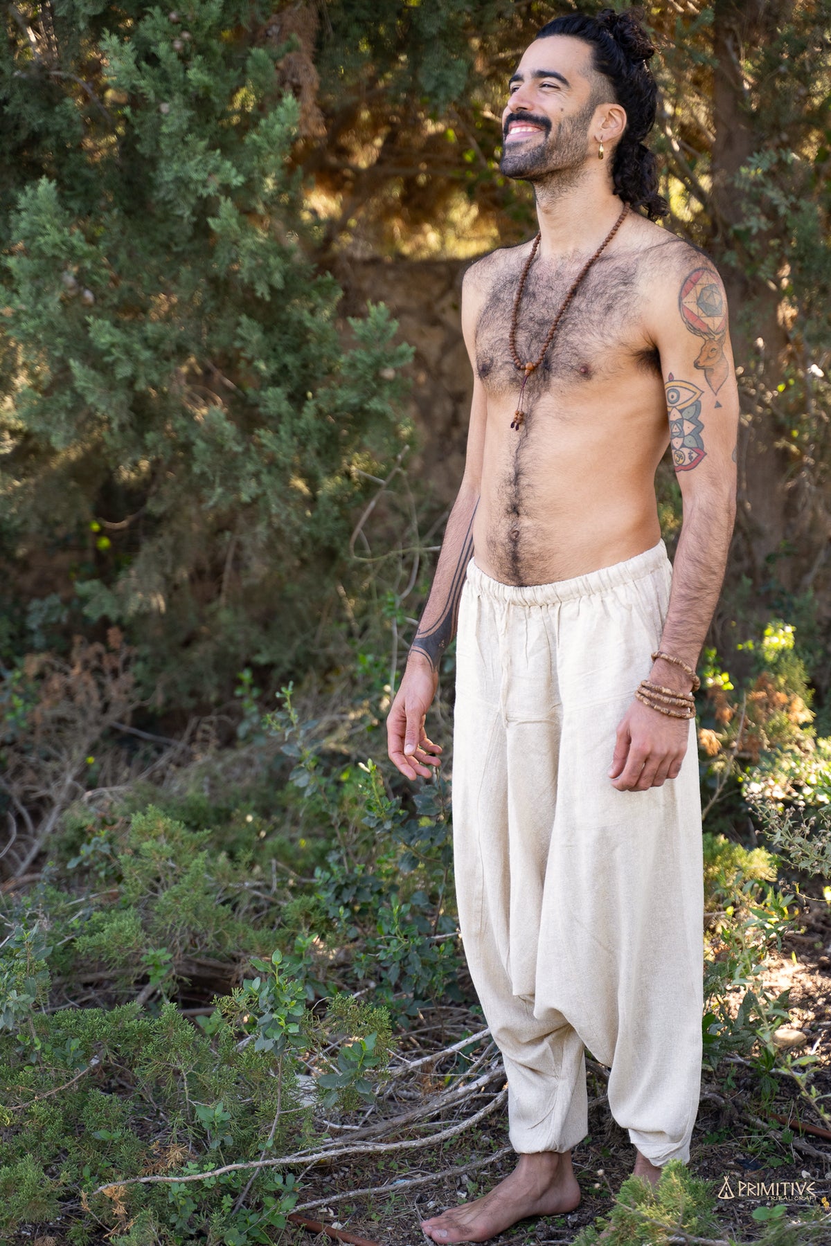 Handwoven raw silk afghani pants in natural off-white on a man, airy loose fit with elastic waist for comfort, movement and boho style.