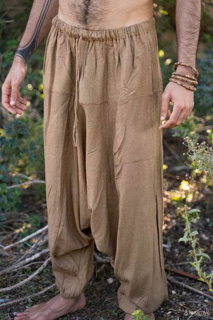 Close-up of handwoven raw silk afghani pants in earthy brown, showing elastic waistband, roomy drape and relaxed boho fit.
