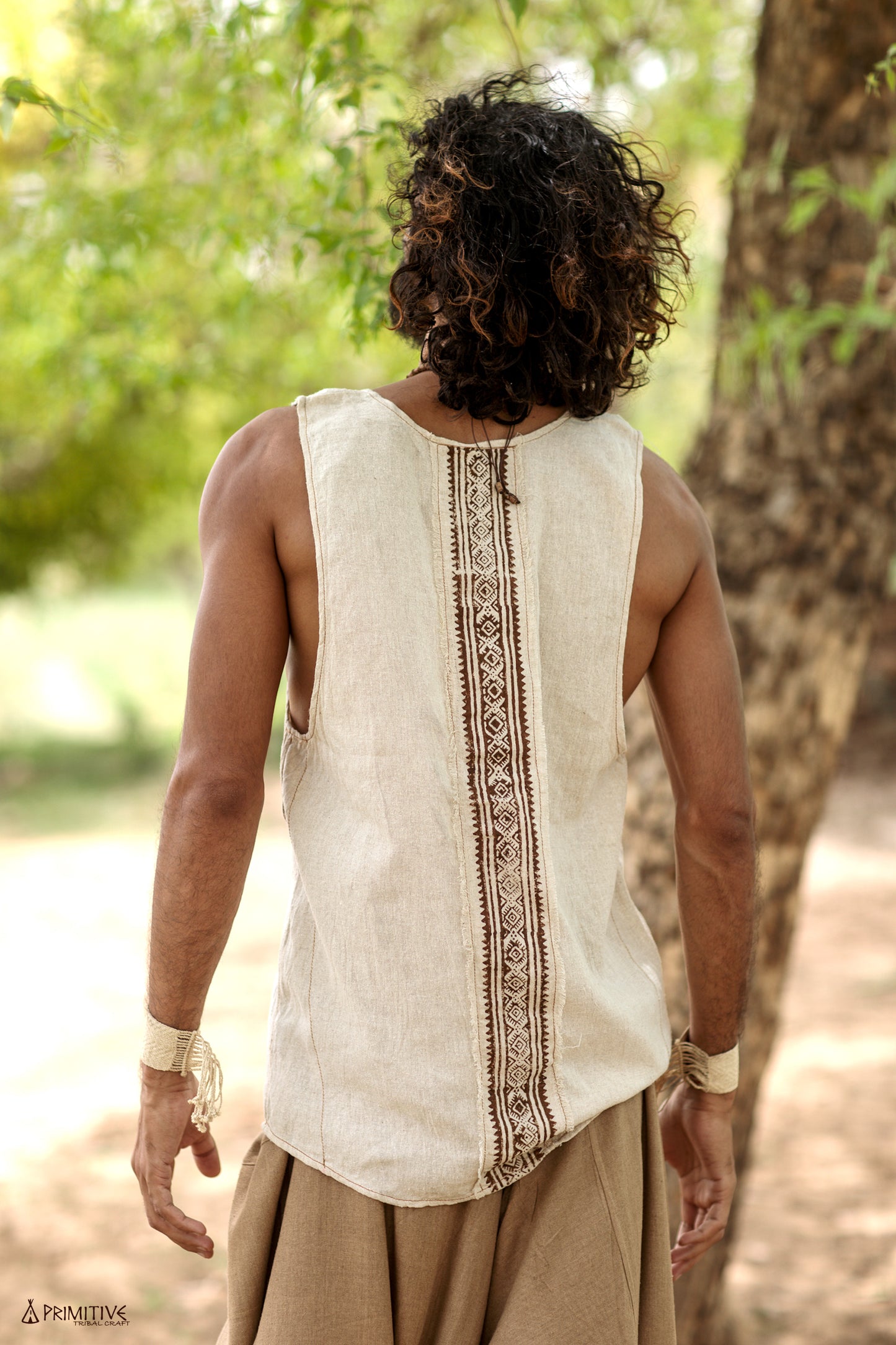 Back view of a handwoven raw silk tank top showing the vertical tribal block print running down the center.