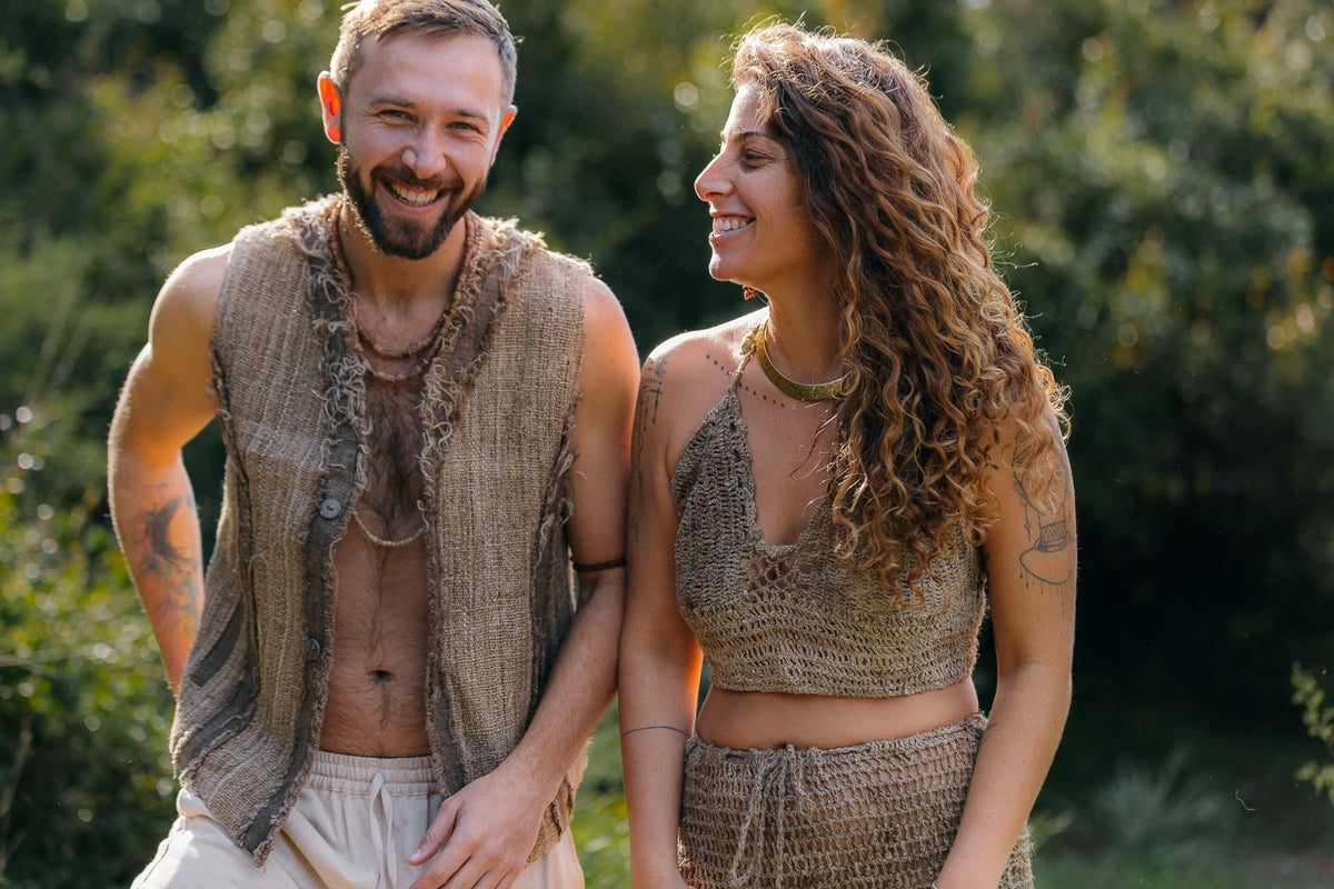 Man and woman wearing handwoven Himalayan nettle clothes in a natural outdoor setting.