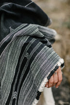 Handloom handwoven black organic cotton shawl with white tribal pattern and fringe detail
