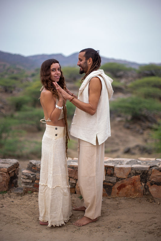 Side view of Two people, the women wearing an undyed handwoven khadi cotton maxi skirt, styled for boho travel and festival layering 