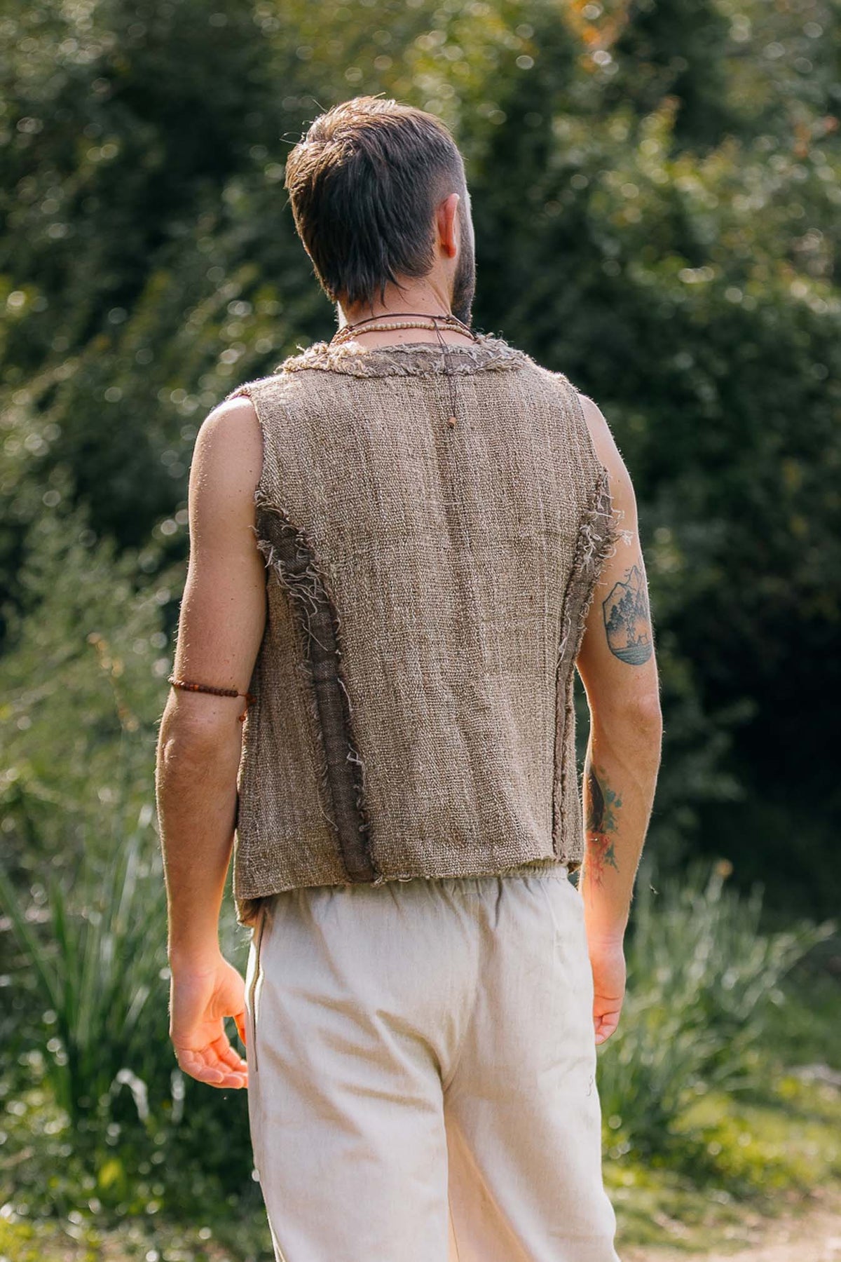 Back view of handwoven Himalayan nettle vest with raw texture and frayed edges.