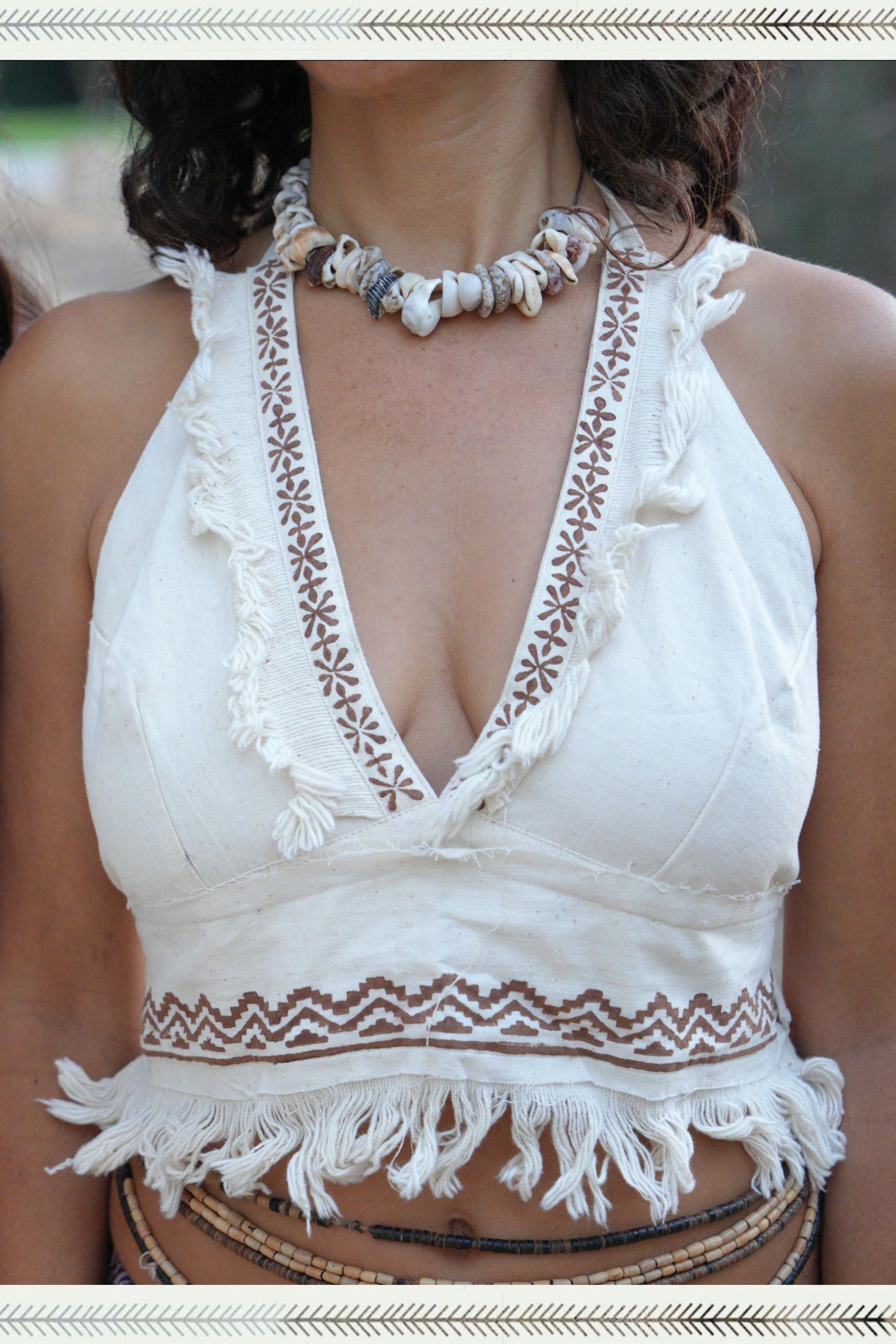 Close-up of a handwoven khadi cotton halter top with deep V-neck, tribal block print trim