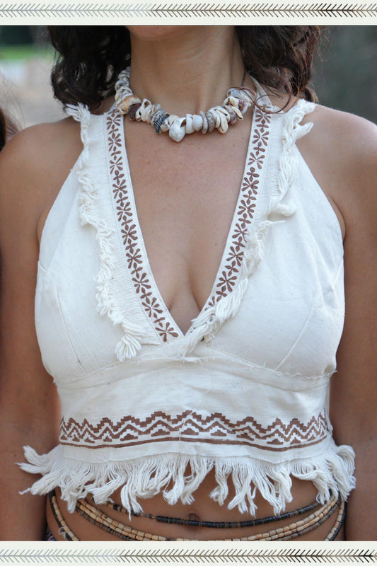 Close-up of a handwoven khadi cotton halter top with deep V-neck, tribal block print trim