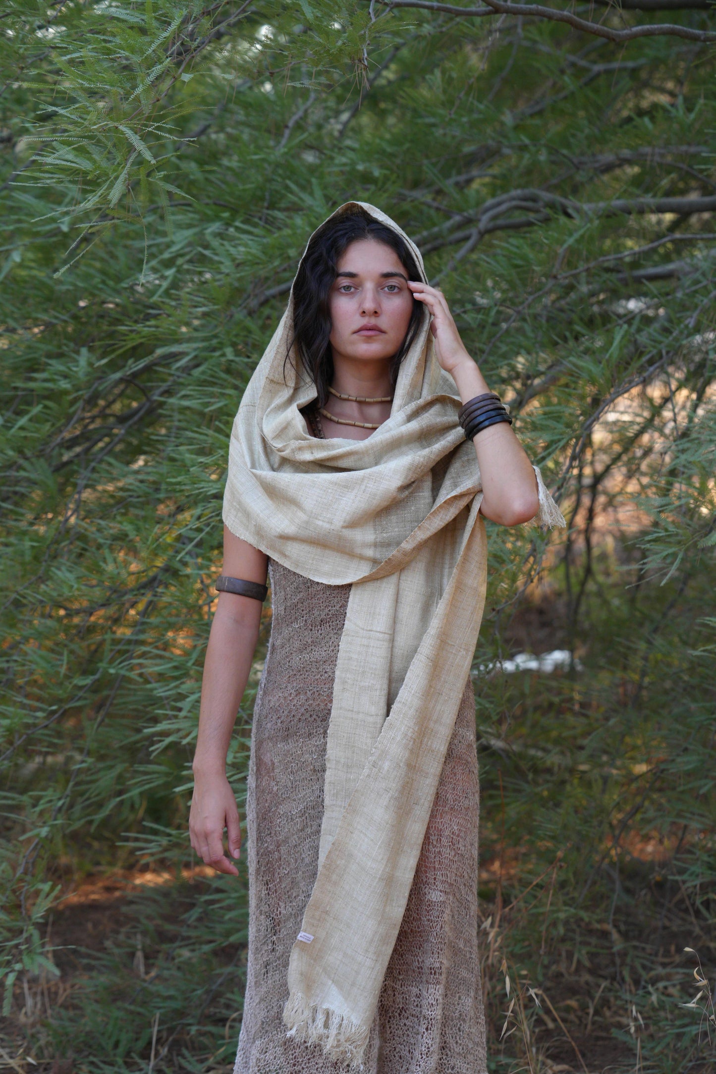 hippie Woman wrapped in a natural handwoven mulberry raw silk shawl, showing the drape and lightweight texture outdoors.