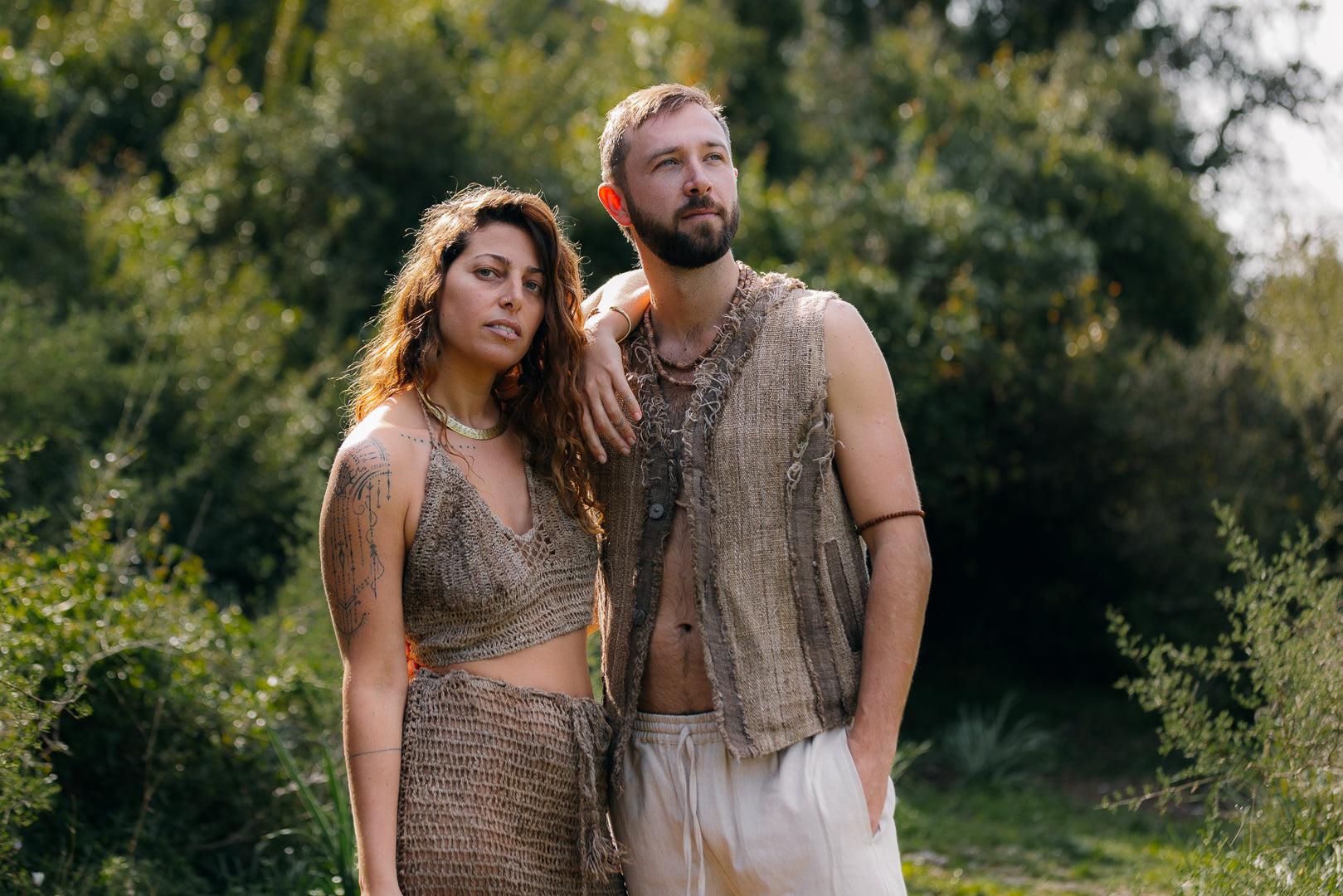 a couple wearing rustic, nettle yarn clothing outdoors