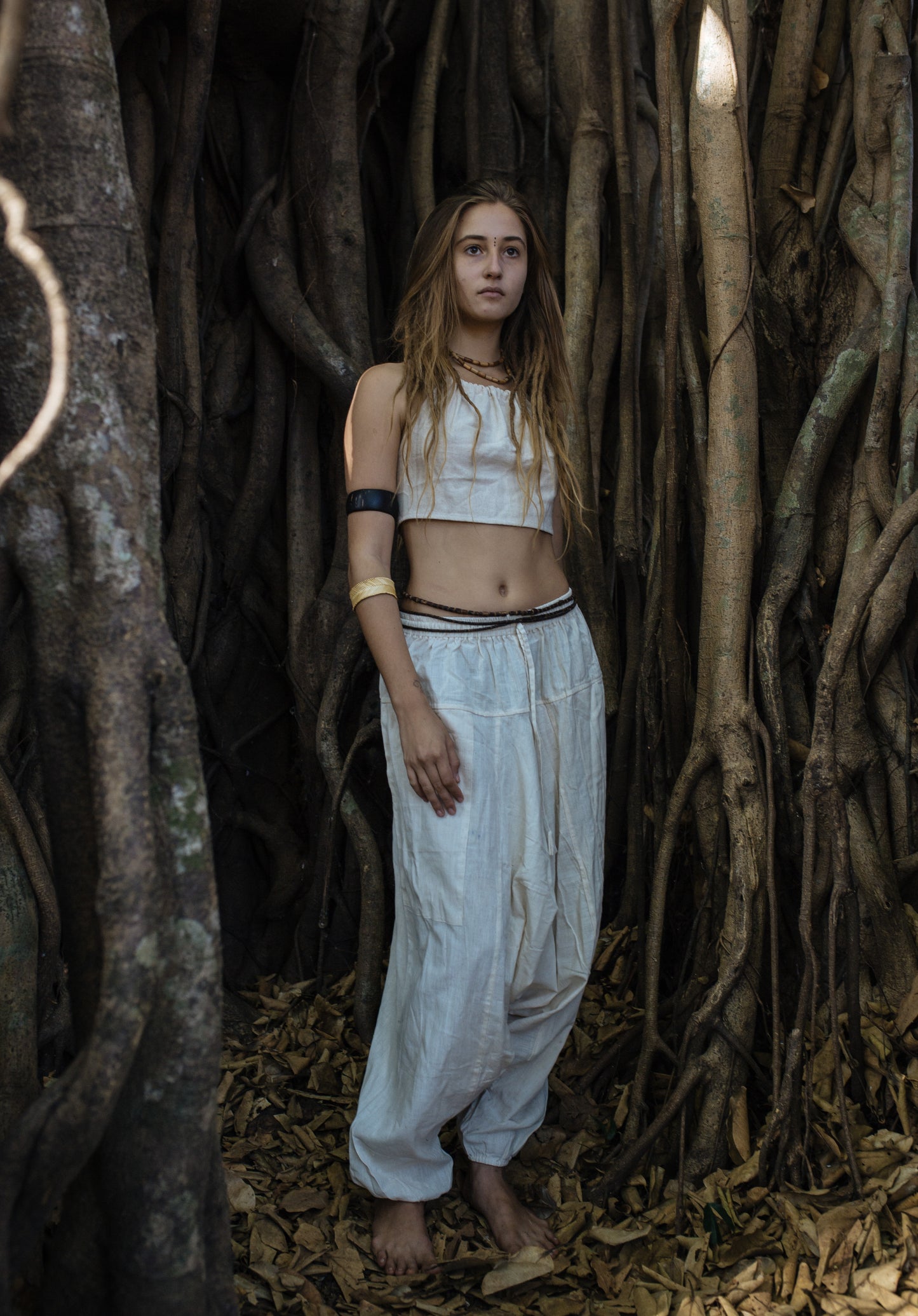 Neutral natural cotton harem pants with relaxed fit and drop-crotch style shown full length on a model, highlighting the loose silhouette and easy everyday boho look.