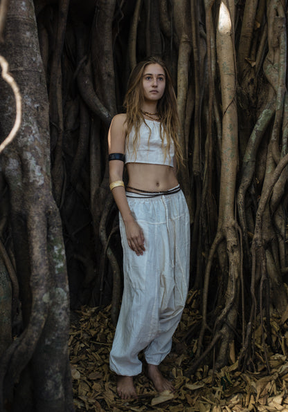 Neutral natural cotton harem pants with relaxed fit and drop-crotch style shown full length on a model, highlighting the loose silhouette and easy everyday boho look.