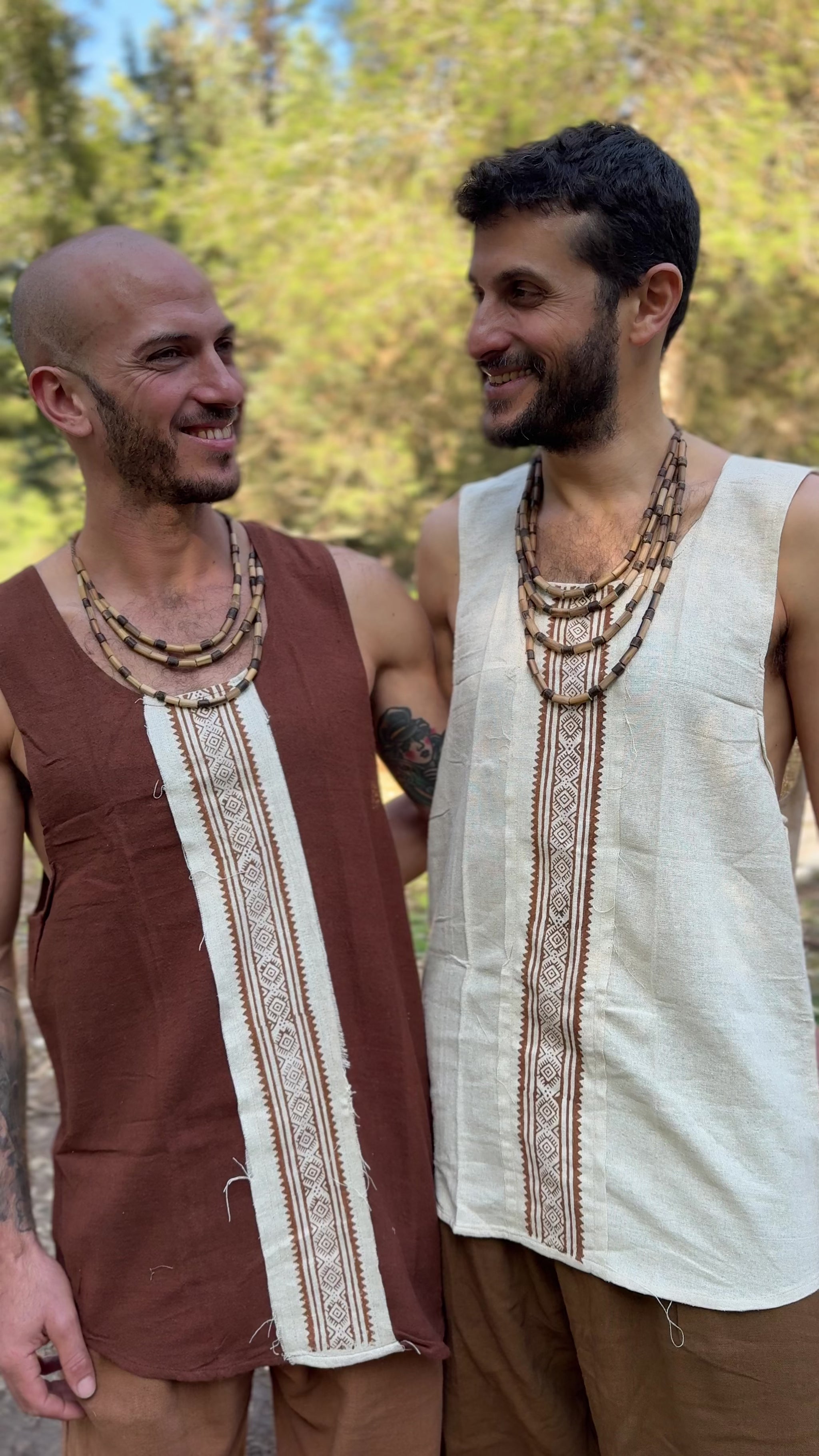 two men wear raw silk sleeveless shirts in brown and in natural color 
