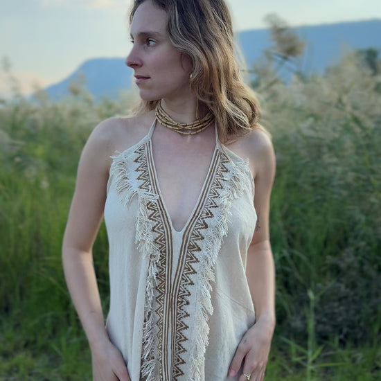 Video showing the fit and flow of the Maya Dress, a lightweight short cotton butterfly dress with patterned front trim.