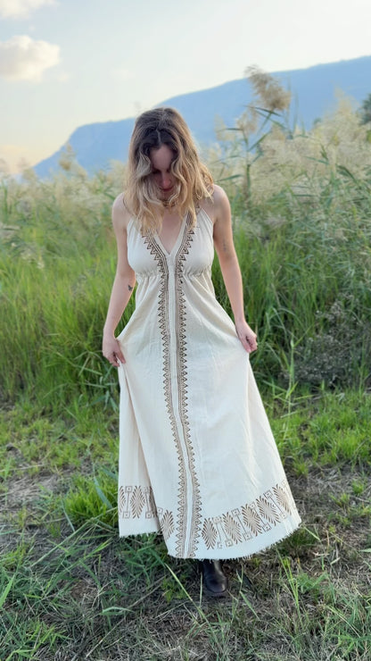 Video showing the fit and flow of the Naya long butterfly dress - a natural cotton maxi dress with block print details - filmed outdoors.
