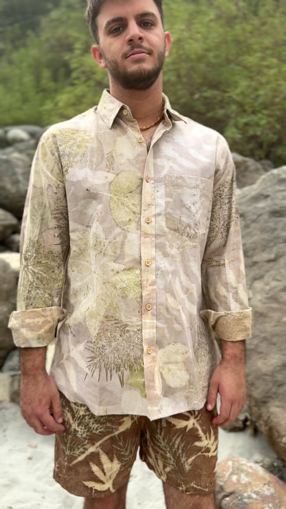 Close up video showing a light earthy botanical print long-sleeve button-down shirt with rolled sleeves. Men's eco-friendly slow fashion