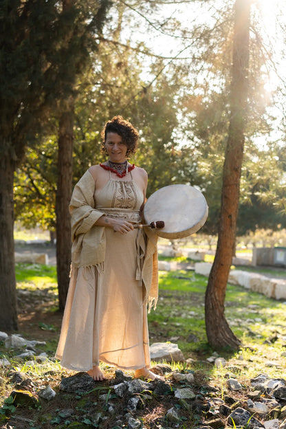 Full body view of a natural wrap skirt, halter top and shawl outfit set in a forest setting, earthy boho style.