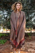 Earth tone brown wool shawl with a traditional red and black geometric border. Handloom bohemian winter stole with fringes, showcasing a warm herringbone texture.