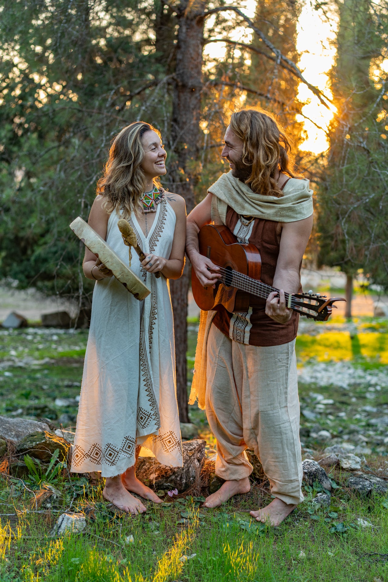 A couple wearing handmade tribal block print clothing made of natural cotton, featuring a flowy ethnic dress and a matching men's top.