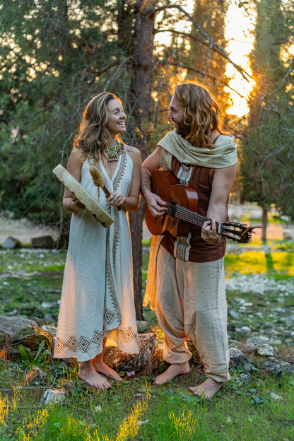 A couple wearing handmade tribal block print clothing made of natural cotton, featuring a flowy ethnic dress and a matching men's top.