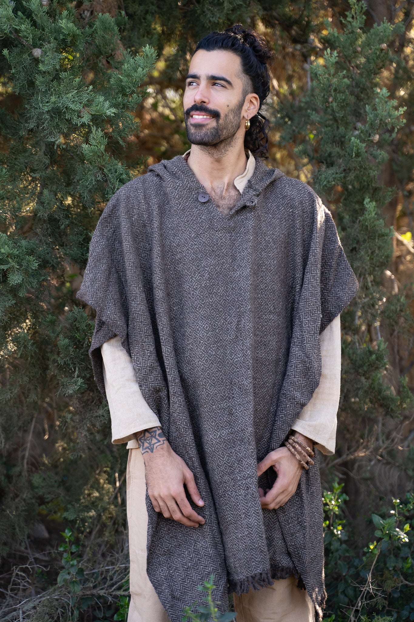 A man wearing warm wool poncho 