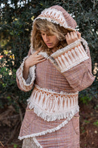 Detail of hand-drawn tribal embroidery on the hood of a woven Khadi cotton jacket. Bohemian artisan fashion.