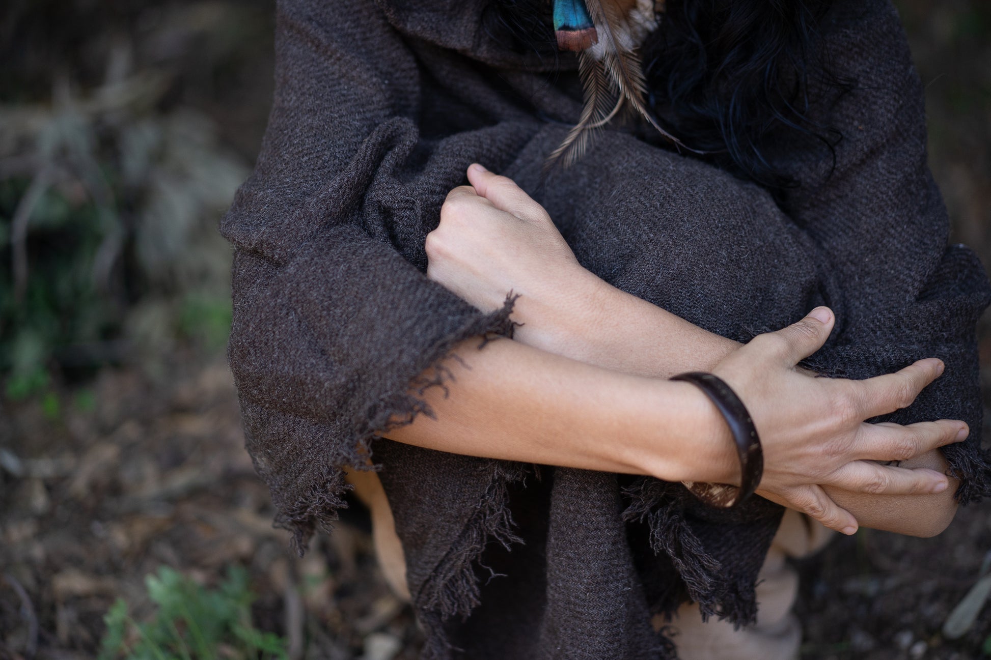 a woman with her hands wrapped around her body