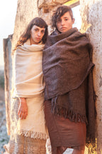 Two Women wearing handwoven natural wool shawls in cream and dark gray as cozy wraps
