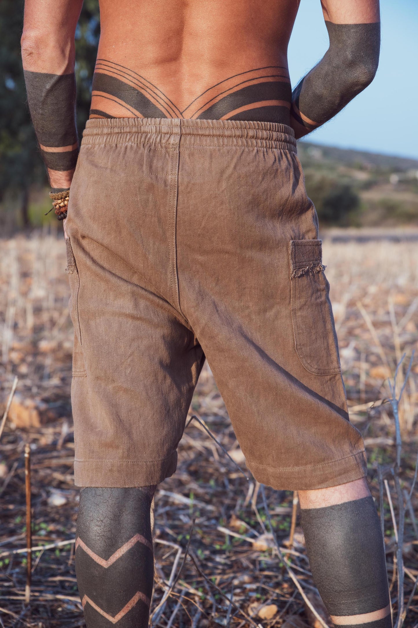 back shot of a man wearing natural dyed hemp shorts