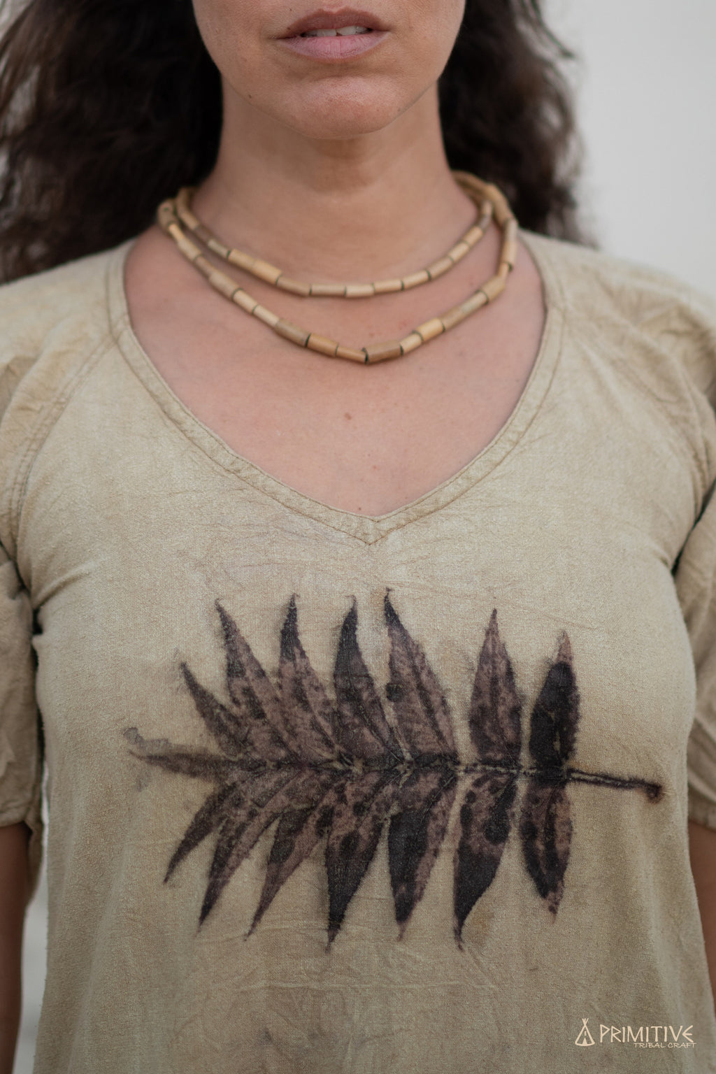 Close-up of raw silk dress with leaf print, light brown vintage style fabric.