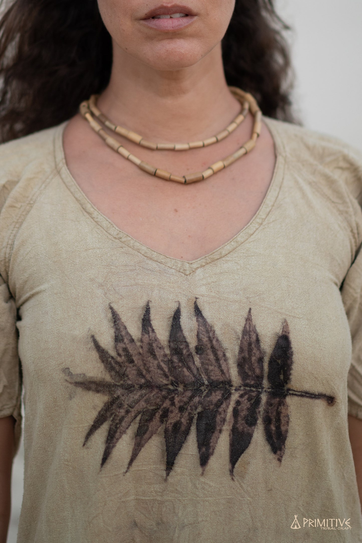 Close-up of raw silk dress with leaf print, light brown vintage style fabric.