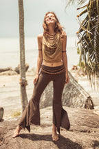 Women wearing brown organic cotton bell bottom yoga leggings, full length front view